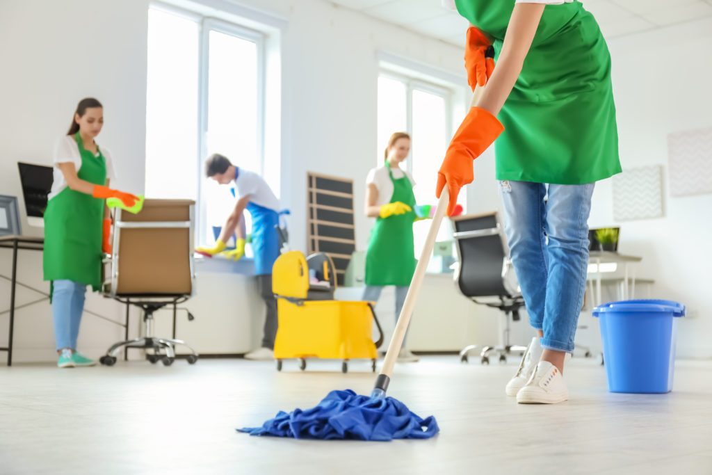 Team of Janitors Cleaning at the Office